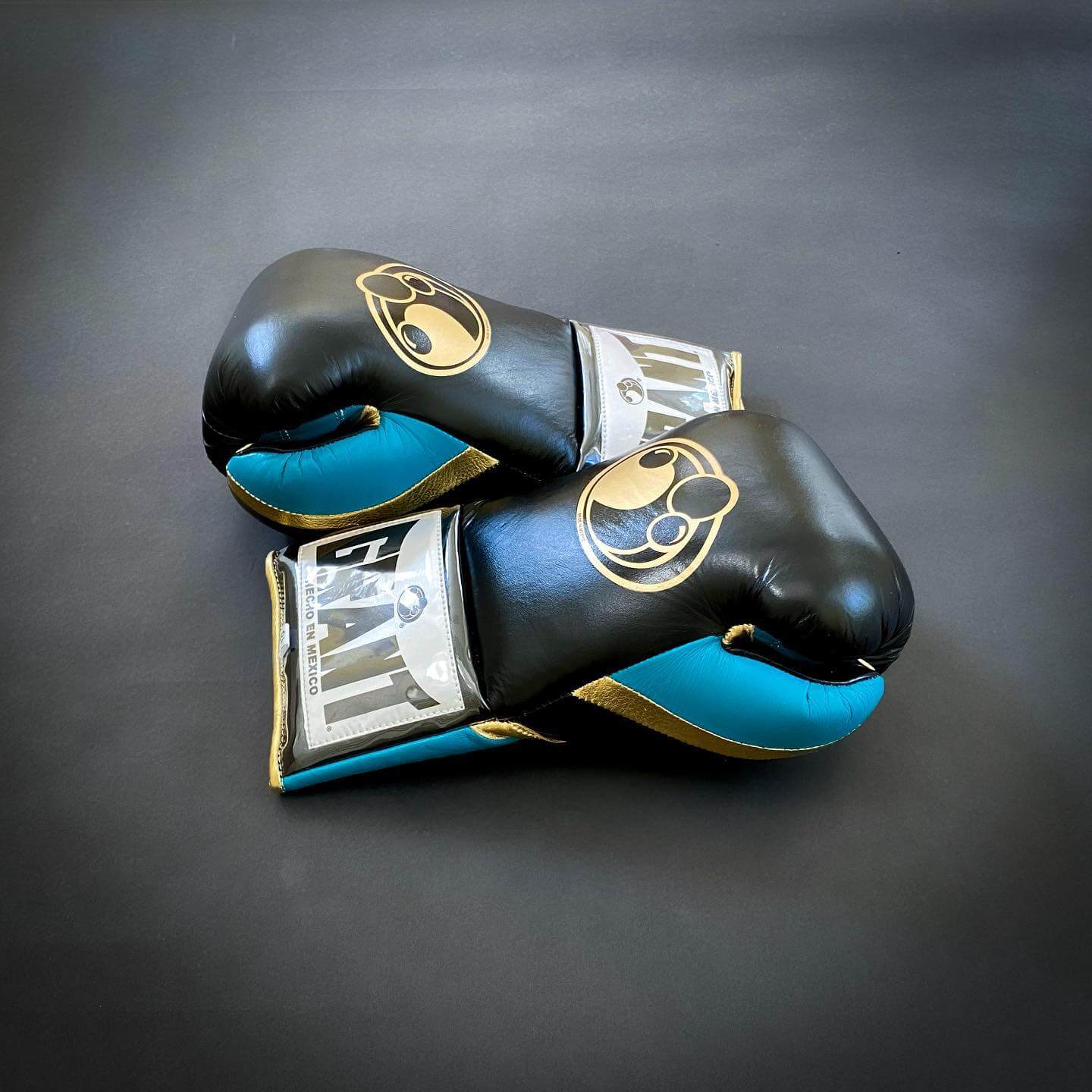 Grant Boxing Gloves in Black/Blue/Gold colorway - Professional Lace-Up training gloves