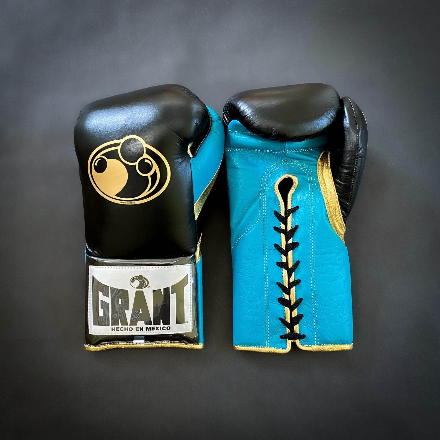 Grant Boxing Gloves in Black/Blue/Gold colorway - Professional Lace-Up training gloves