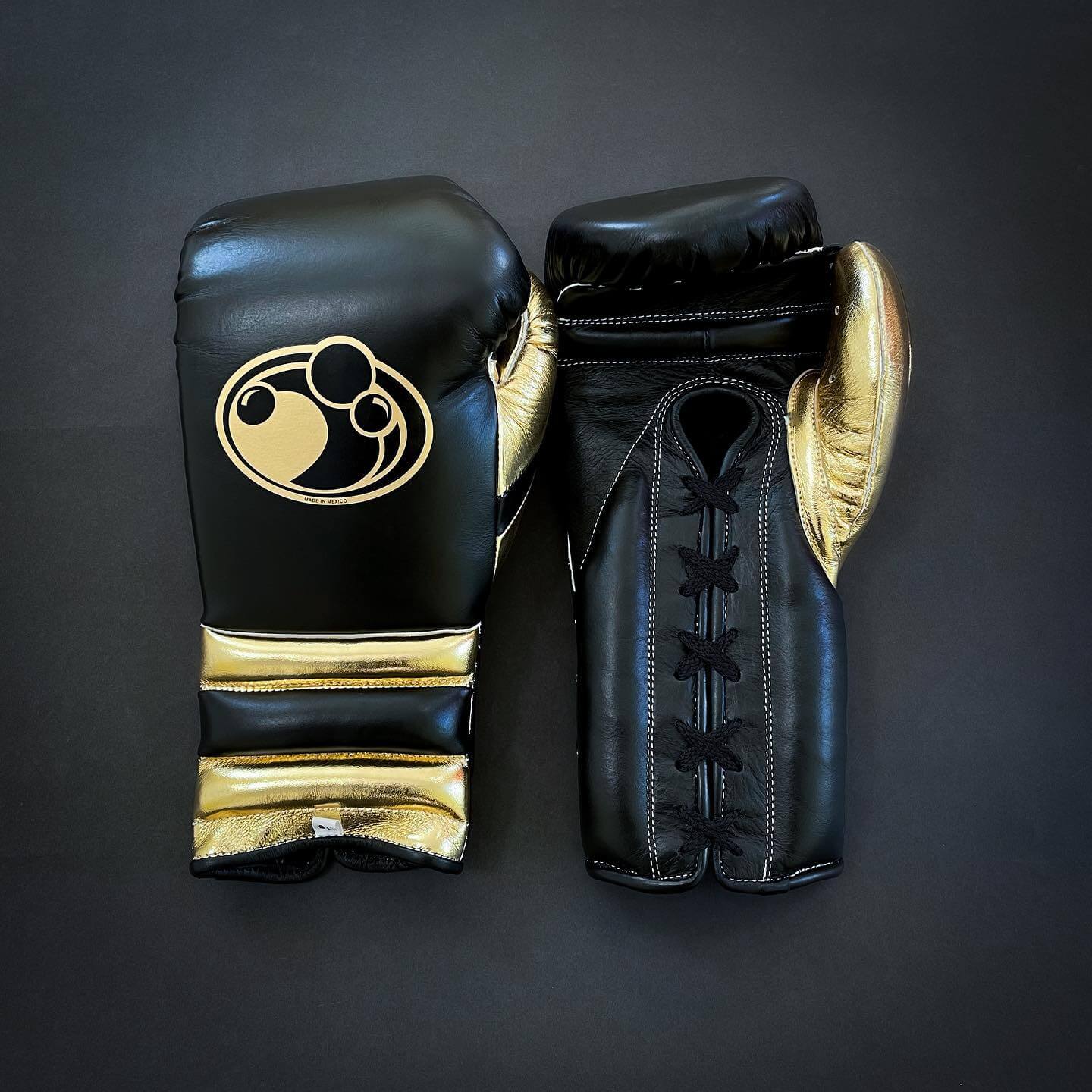 Grant Boxing Gloves in Black/Gold colorway - Professional Lace-Up training gloves