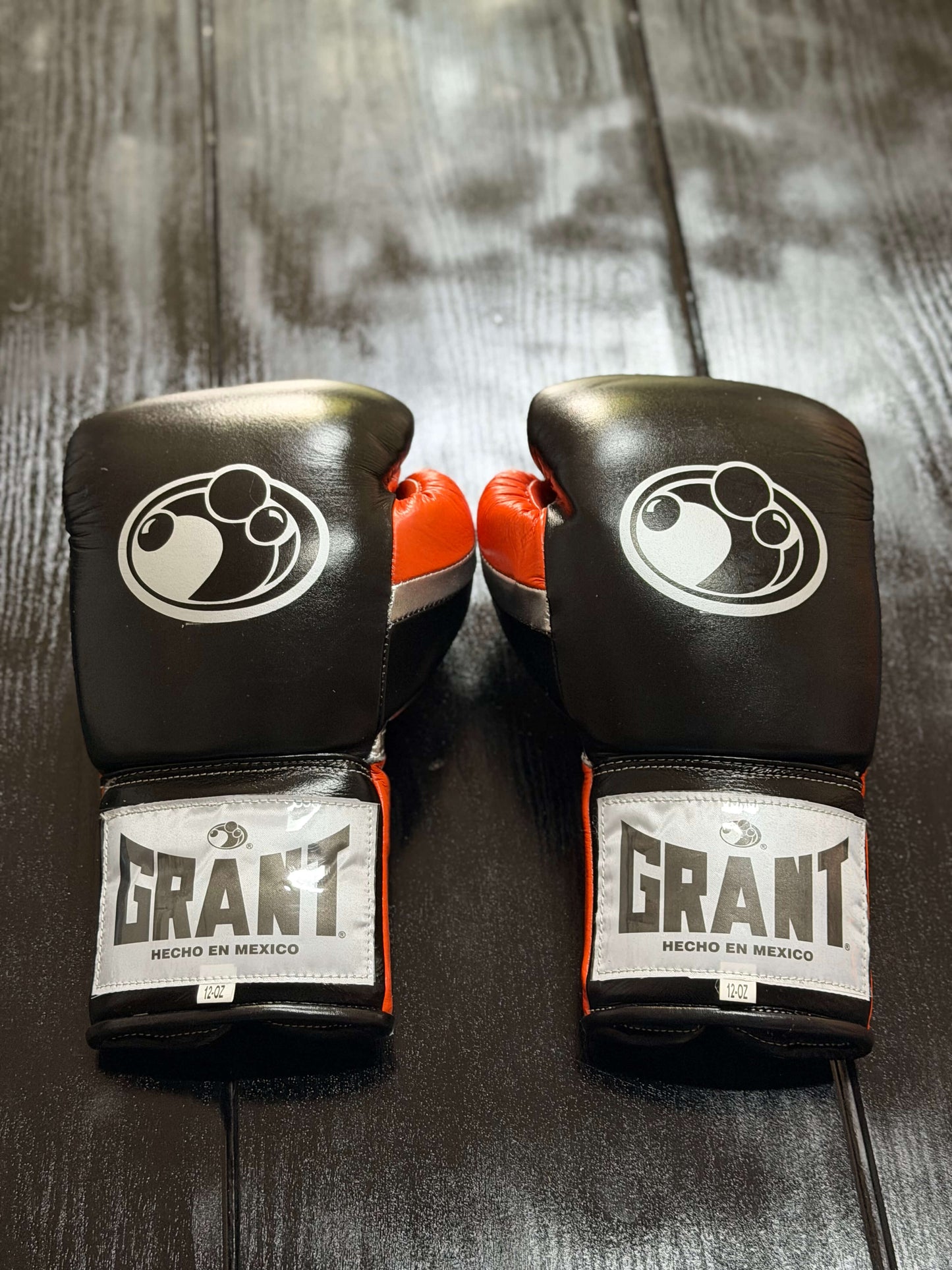Grant Boxing Gloves in Black/Orange/Silver colorway - Professional Lace-Up training gloves