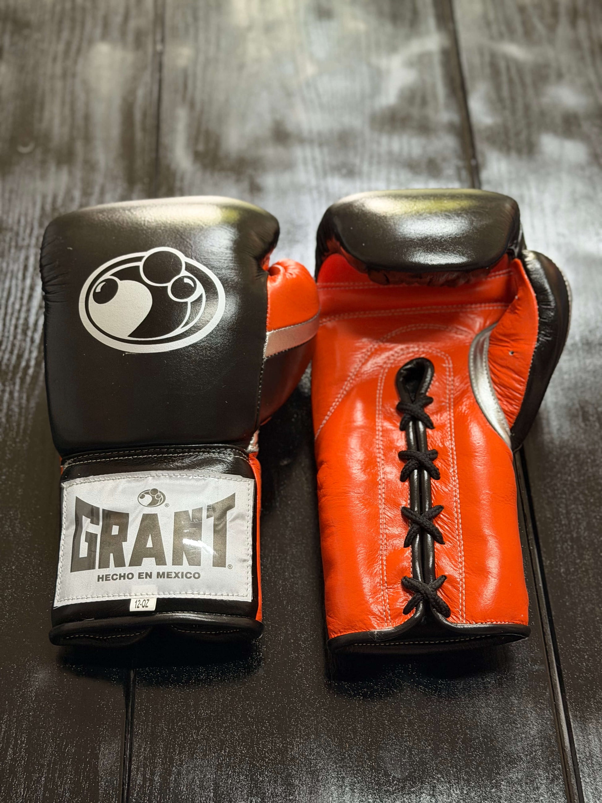 Grant Boxing Gloves in Black/Orange/Silver colorway - Professional Lace-Up training gloves