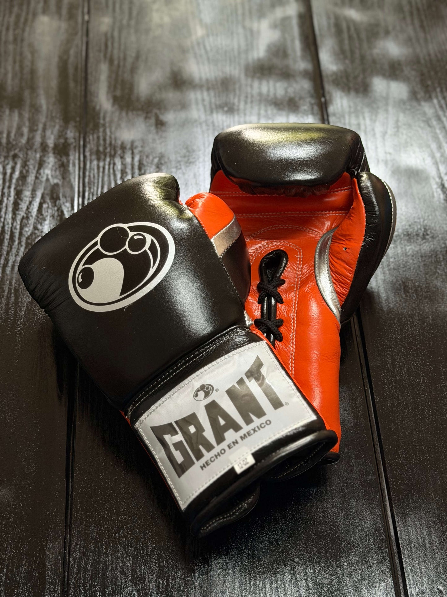 Grant Boxing Gloves in Black/Orange/Silver colorway - Professional Lace-Up training gloves